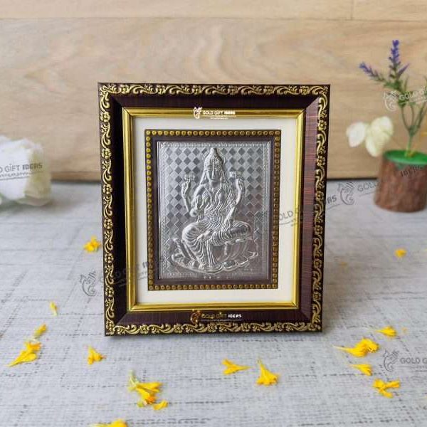 Lakshmi photo frame, silver lakshmi frame, silver lakshmi photo frame, silver laxmi frame silver gift items return gifts for housewarming silver pooja items silver gift articles Lakshmi photo frame, lakshmi devi photo frames, goddess lakshmi photo frame, lakshmi frame with charan paduka, mahalaxmi photo frame, Kolhapur mahalaxmi photo frame, return gifts for Diwali, photo frame for gift religious frame for worship, return gifts