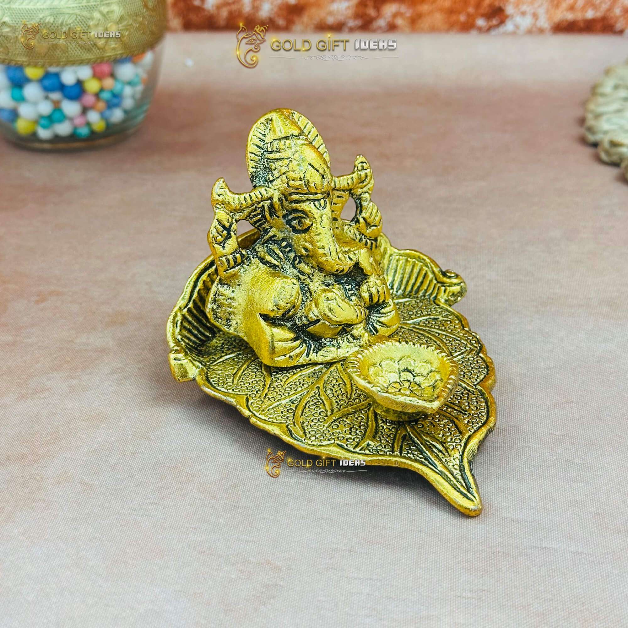 Gold Plated Pan Shape Ganesha Diya (1) ganesha on leaf, lord ganesha on leaf, ganesha sitting on leaf, metal ganesha on leaf, ganesh idol on leaf, ganesh ji on leaf, ganpati on leaf, ganpati bappa on leaf, ganesh idol for home, ganesh idol for home vastu, ganesh idol for home decor, ganesh idol for office, ganesh idol for office desk, ganesh idol for study table, ganesh murti for home, ganesh murti for gift, ganesh murti for office, ganesh statue for home, ganesh statue for gift, ganesh statue for office, ganesh statue for ganesh chaturthi, ganesh statue for temple, ganesha idol for home, ganesha idol for gift, ganesha idol for office, ganesha idol for office desk, ganesha idol for home decor, ganesha idol for study table, ganesha idol for pooja room, ganesha murti for home, ganesha murti for ganesh chaturthi, ganesha statue for gift, ganesha statue for home decor, ganesha statue for home, ganesha statue for pooja room, ganesha statue for ganesh chaturthi, ganesha statue for home vastu, ganpati idol for home decor, ganpati idol for home, ganpati idol for office desk, ganpati idol for gift, ganpati idol for office, ganpati murti for home, ganpati murti for ganesh chaturthi, ganpati murti for gift, ganpati statue for gift, ganpati statue for home, return gifts for pooja, diwali gift, diwali return gift, birthday gift, birthday return gift, return gifts, wedding gift, wedding return gift, baby shower gift, baby shower return gift, occasional gift, housewarming gifts, housewarming return gifts,